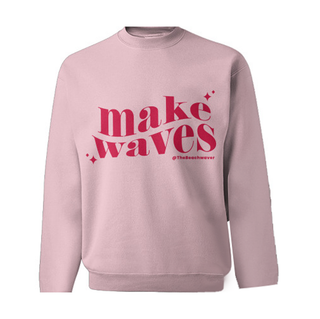 Pink Crewneck with wavy text that said reads make waves with sparkles on either end and @thebeachwaver on the bottom, all in a bright pink.