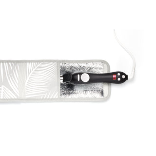 Image of Grey storage pouch decorated with palm leaves that is open with a Beachwaver hair tool sticking out of it.