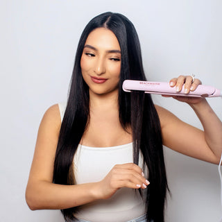 Image of model with long brunette hair using the pink coast pro to make her hair smooth and sleek. 