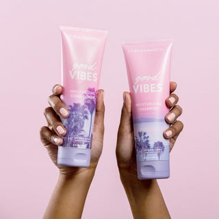 Photo of someone holding up Beachwavers Good Vibes Shampoo and Conditioner.