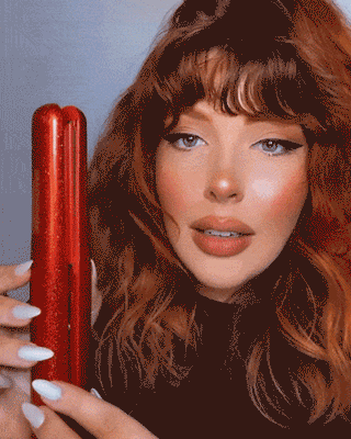 Video of Red headed model using the red glitter coast pro straightener on her wavy textured hair