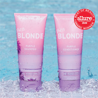 Photo of Beachwavers BRB Blonde Purple Shampoo and Conditioner with the "Allure Best of Beauty" stamp on it. On a background that looks like splashing water.