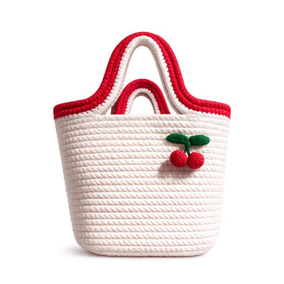 White woven bag with red accents and cherry decoration on a white background