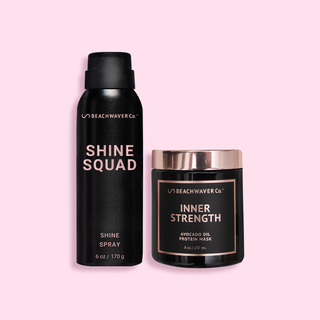 Black aerosol can of Shine Squad Shine Spray next to black and rose gold tub of Inner Strength Hair Mask