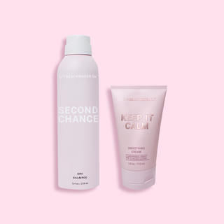Pink aerosol can of Second Chance Dry Shampoo next to Keep it Calm Smoothing Cream.