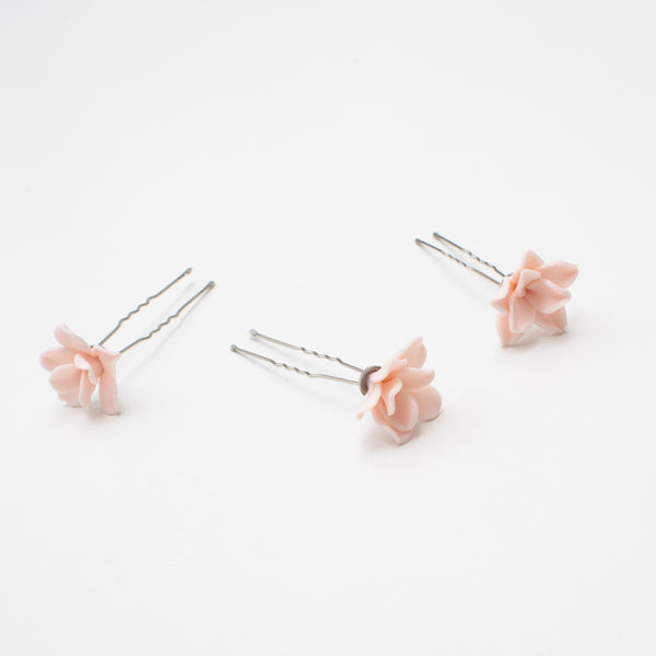 Image of the pink floral hairpins scattered on the table