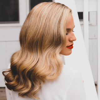 Image of Blonde model with red lipstick and a white outfit showing off her glam waves created by the Beachwaver Pro 1 