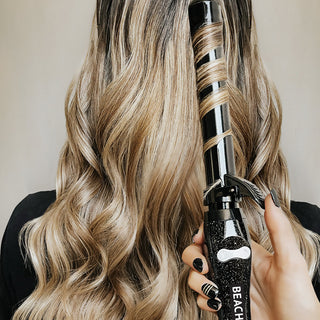 image of hair that has been styled with a Beachwaver® B1 Black Glitter with the tool held in the hair.