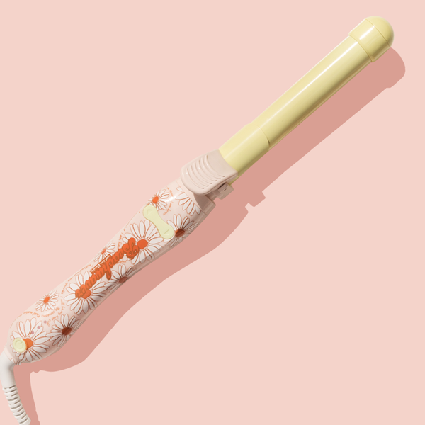 Image of pink and yellow daisy B1 Beachwaver on pink background