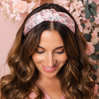 Model with medium length brunette hair style by Beachwaver hair tool wearing the pink floral print knotted headband