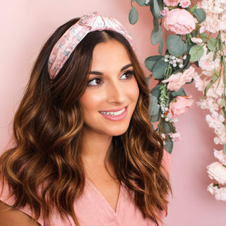 Model with medium length brunette hair style by Beachwaver hair tool wearing the pink floral print knotted headband