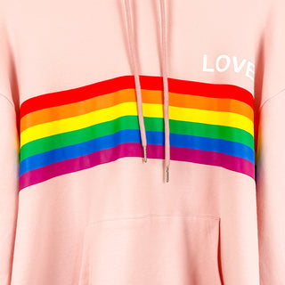 up close image of light pink hoodie with rainbow going down the center and love written on it