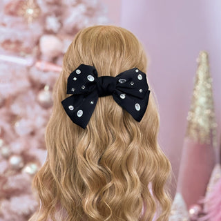 image of long golden hair styled in with a Beachwaver hair-tool pulled away from the face in a Black Rhinestone Silky Oversized Hair Bow.