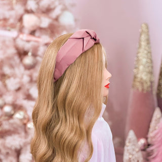 Image of mannequin with long strawberry blonde hair styled by a Beachwaver Hair Tool wearing a Pink Silk Knotted Headband.