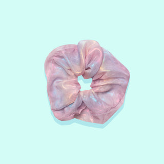 Image of pastel rainbow iridescent scrunchie on teal background