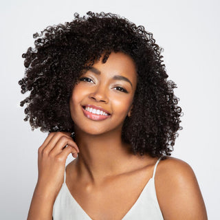 Image of model with dark, defined, curly textured hair.