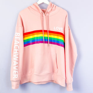 Image of light pink Beachwaver love hoodie with rainbow in the center