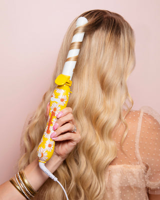 Image of white and yellow daisy B1 Beachwaver in Blonde models hair.