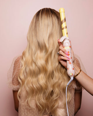 Image of pink and yellow daisy B1 Beachwaver in Blonde models hair
