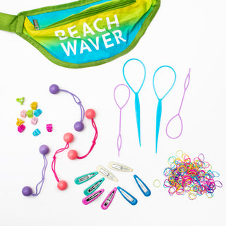 Image of neon Beachwaver fanny pack in a yellow and blue ombre pattern with a variety of hair accessories such as neon hair clips, neon rubber bands, and ponytails with plastic balls.