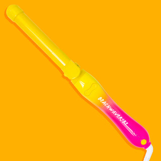 Yellow and pink ombre neon Beachwaver B1 on an orange background.