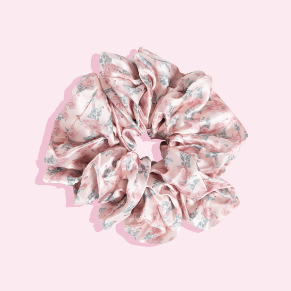 Image of pink floral oversize scrunchie with pink and green flowers on it